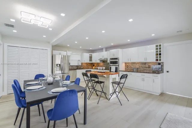 a kitchen with a table and chairs in it