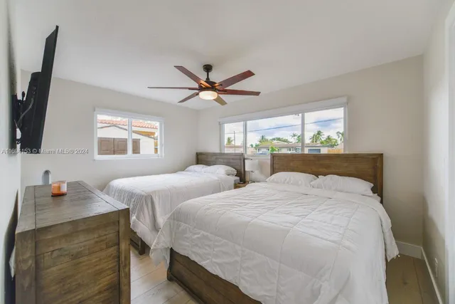 a bedroom with two separate beds and a window