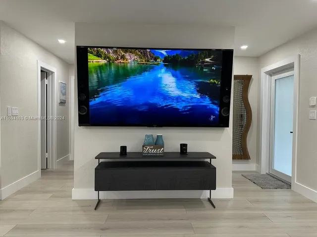 a room with a bed and a flat screen tv