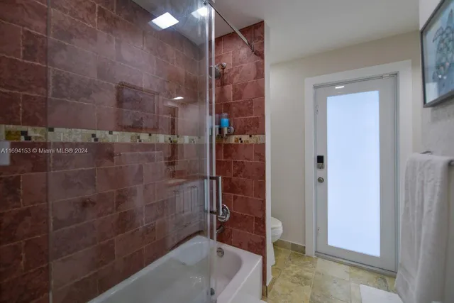 a bathroom with a bathtub and a shower