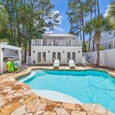 a view of a house with swimming pool and sitting area
