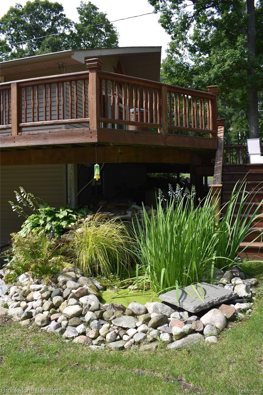 405 Baldwin Ridge Oxford, MI 48371 - Photo 10 of 54 CHECK OUT THE LANDSCAPING POND WITH WATERFALL!!!