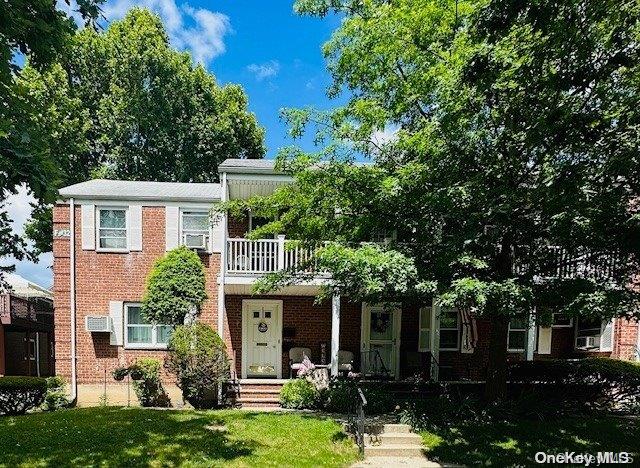 74-61 260th Street, Unit 2 Queens, NY 11004 - Photo 1 of 1 a front view of a house with a yard
