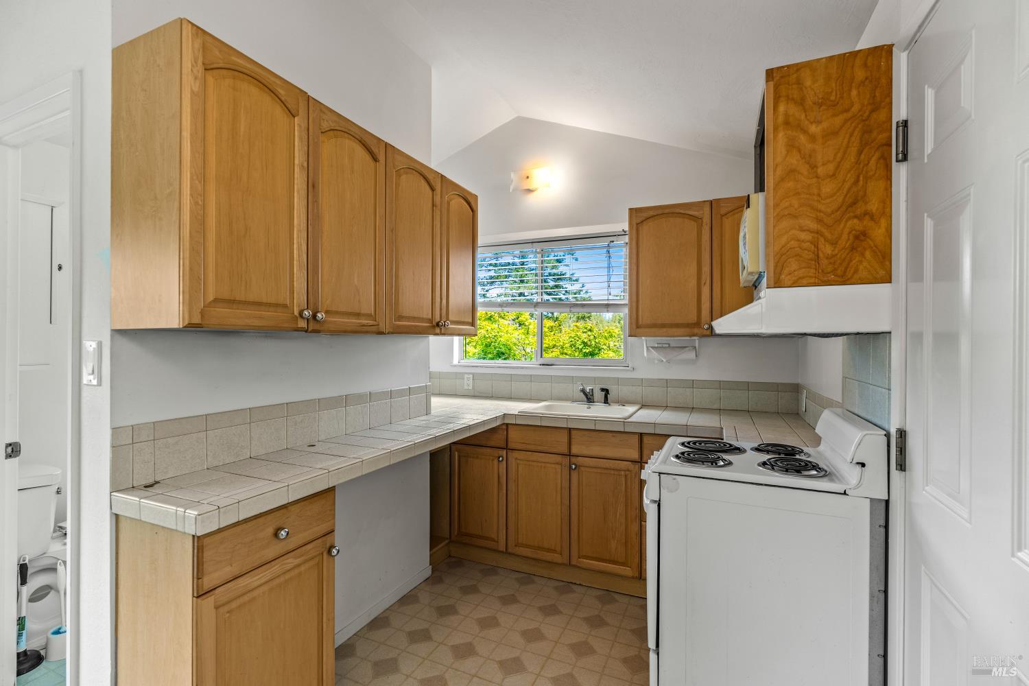625-629 Hill Road Angwin, CA 94508 - Photo 31 of 64 a kitchen with a sink a stove cabinets and a window