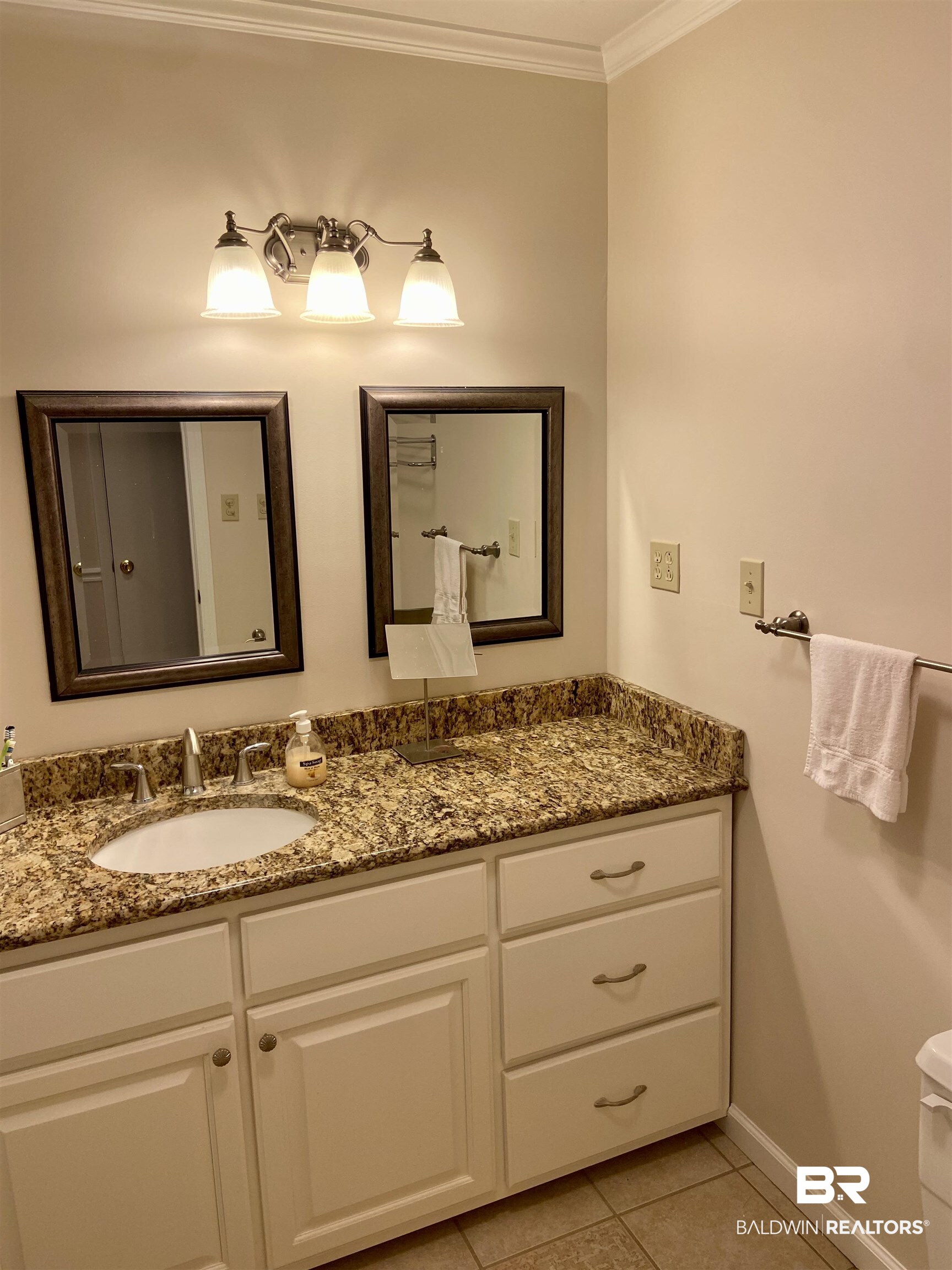 102 Ashley Street Evergreen, AL 36401 - Photo 9 of 26 Bathroom featuring tile patterned flooring, toilet, vanity, and ornamental molding