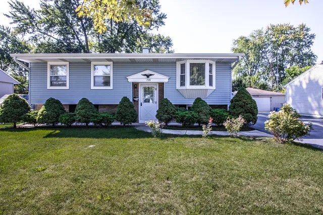 a front view of a house with garden and swimming pool