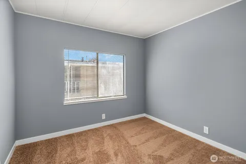 a view of an empty room with closet