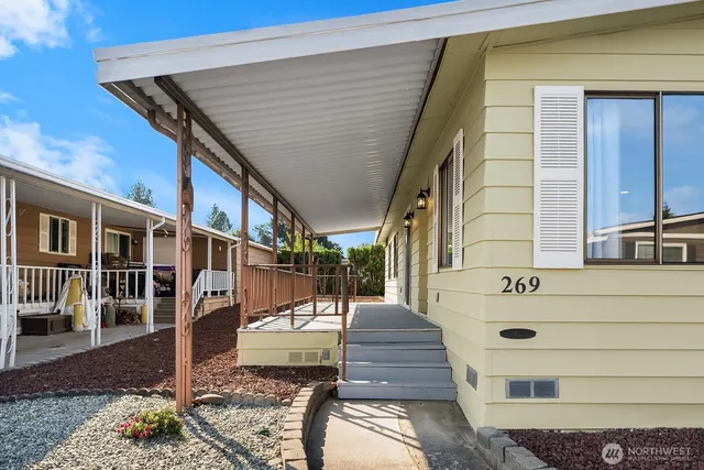 a view of a kitchen with furniture and wooden floor