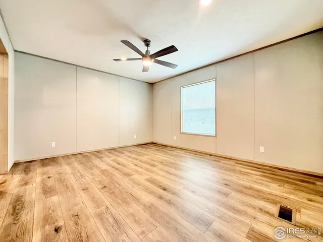 an empty room with cabinet and a ceiling fan