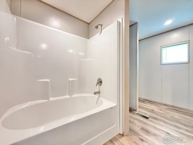 a bathroom with a bathtub and a shower