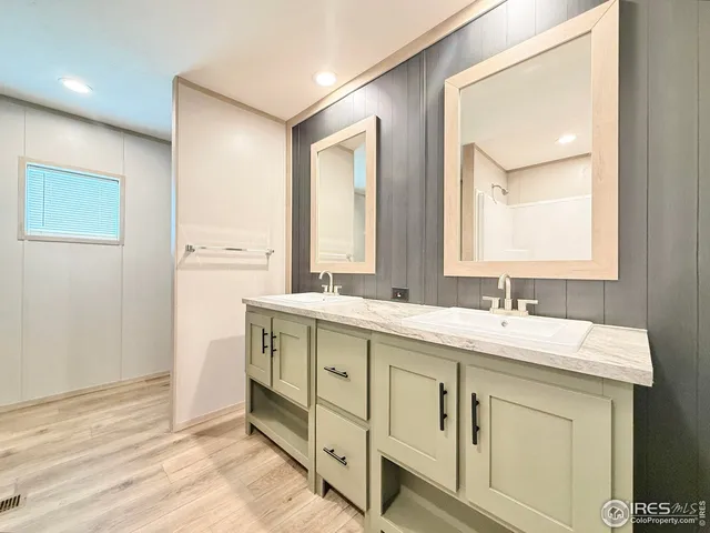 a bathroom with a sink vanity and mirror