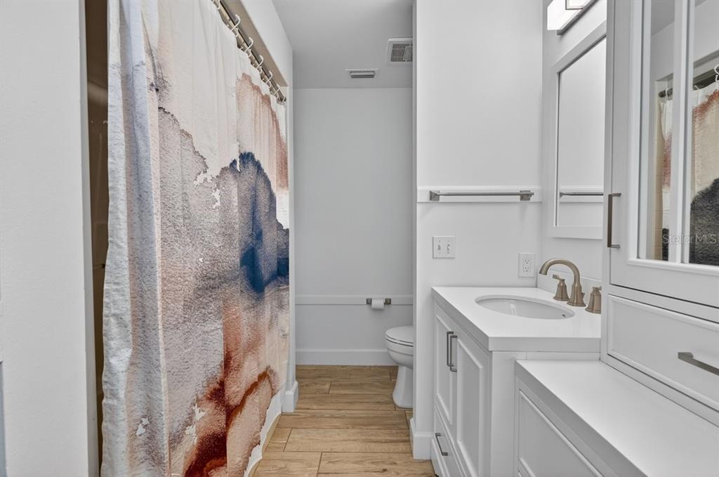171 William Street Edgewater, FL 32141 - Photo 22 of 40 a bathroom with a sink a toilet and shower