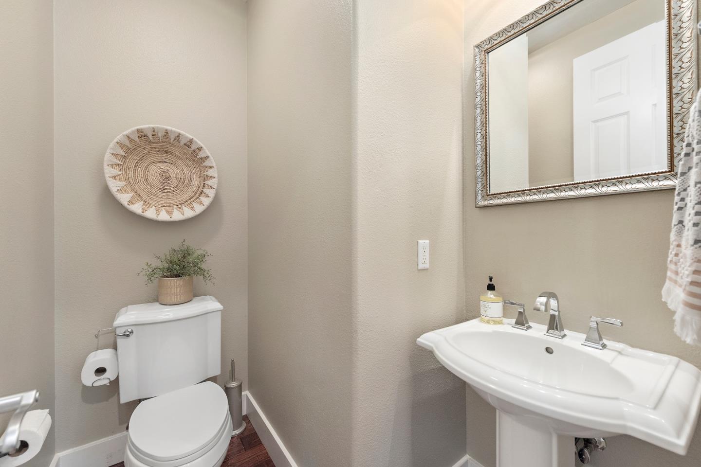 7581 Edinburgh Way Gilroy, CA 95020 - Photo 14 of 38 a bathroom with a sink a toilet and a mirror