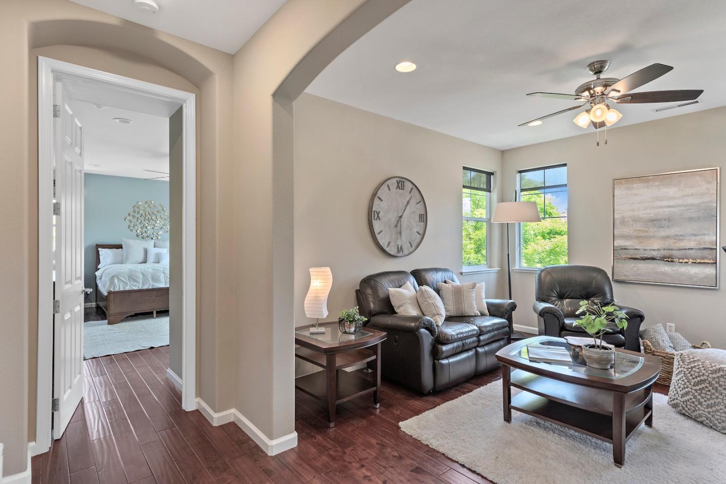 7581 Edinburgh Way Gilroy, CA 95020 - Photo 19 of 38 a living room with furniture and a large mirror