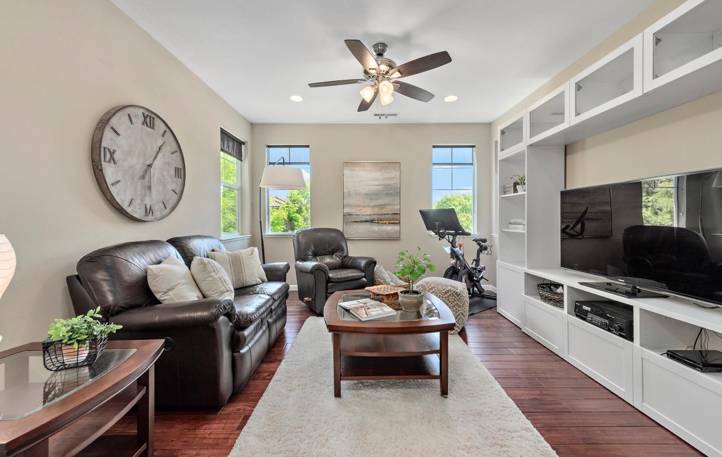 7581 Edinburgh Way Gilroy, CA 95020 - Photo 20 of 38 a living room with furniture a clock on wall and a window
