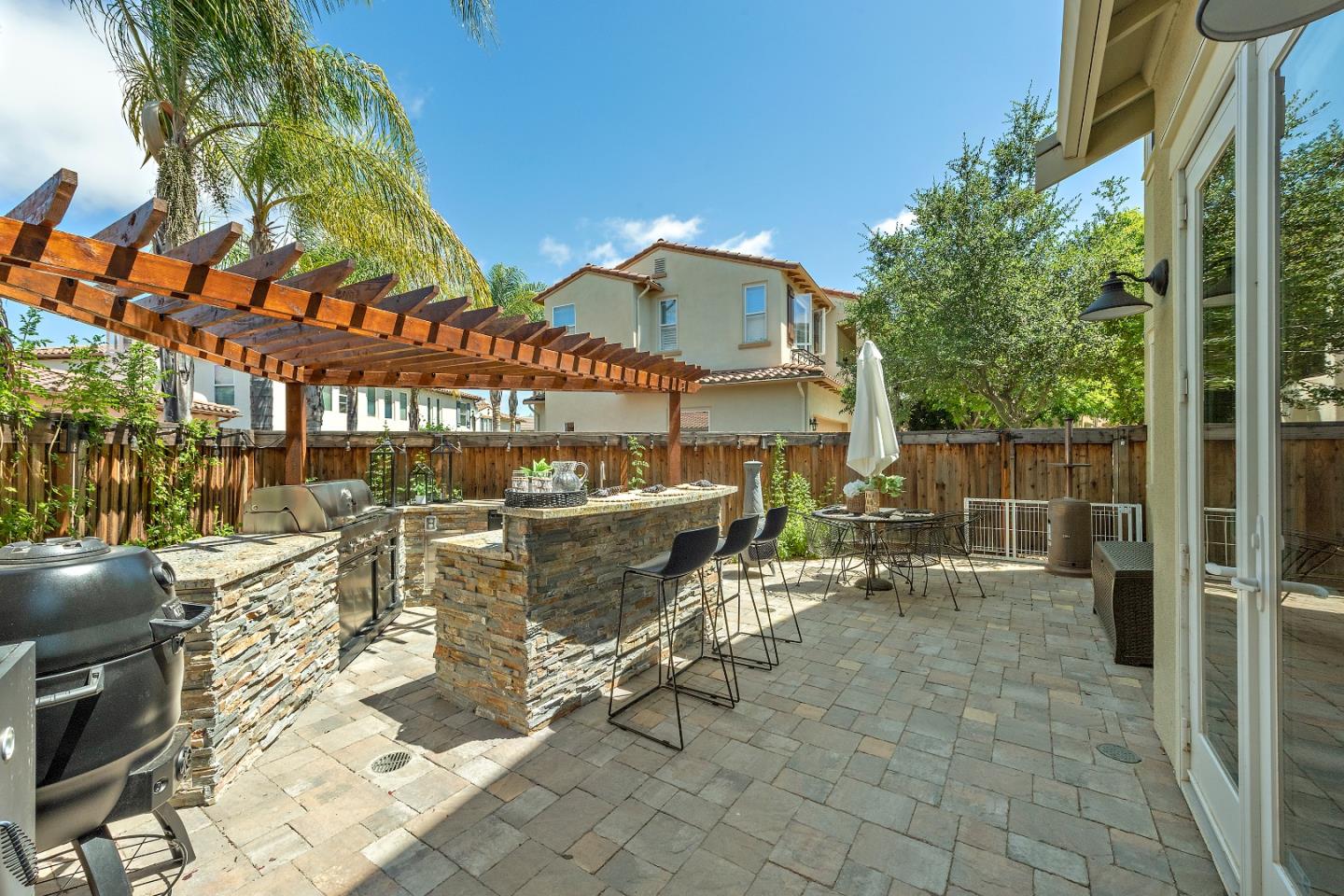 7581 Edinburgh Way Gilroy, CA 95020 - Photo 30 of 38 a view of a patio with table and chairs and potted plants