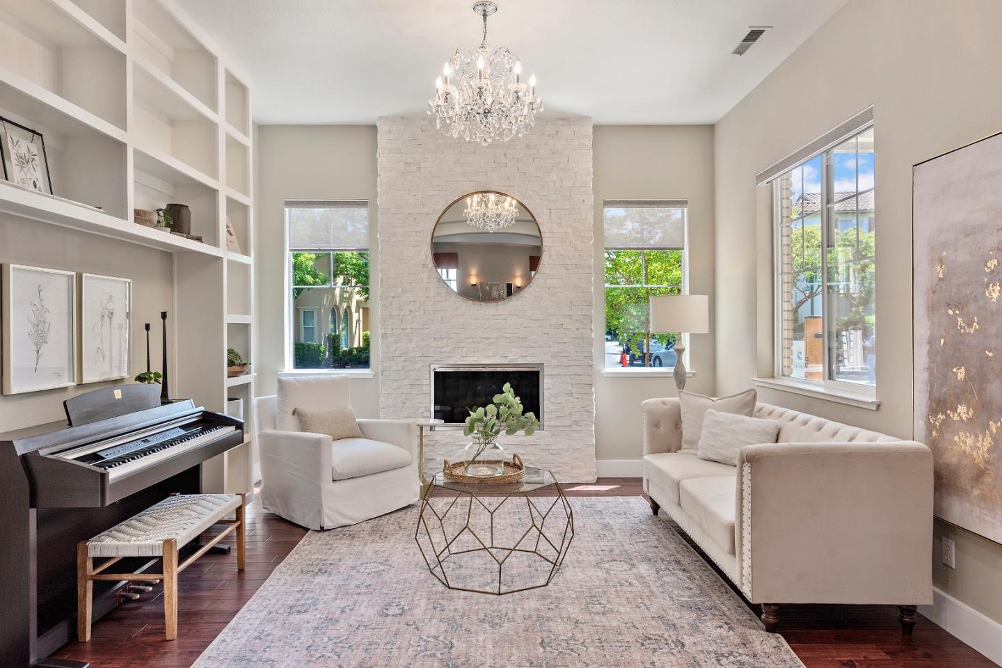 7581 Edinburgh Way Gilroy, CA 95020 - Photo 3 of 38 a living room with furniture a fireplace and a chandelier