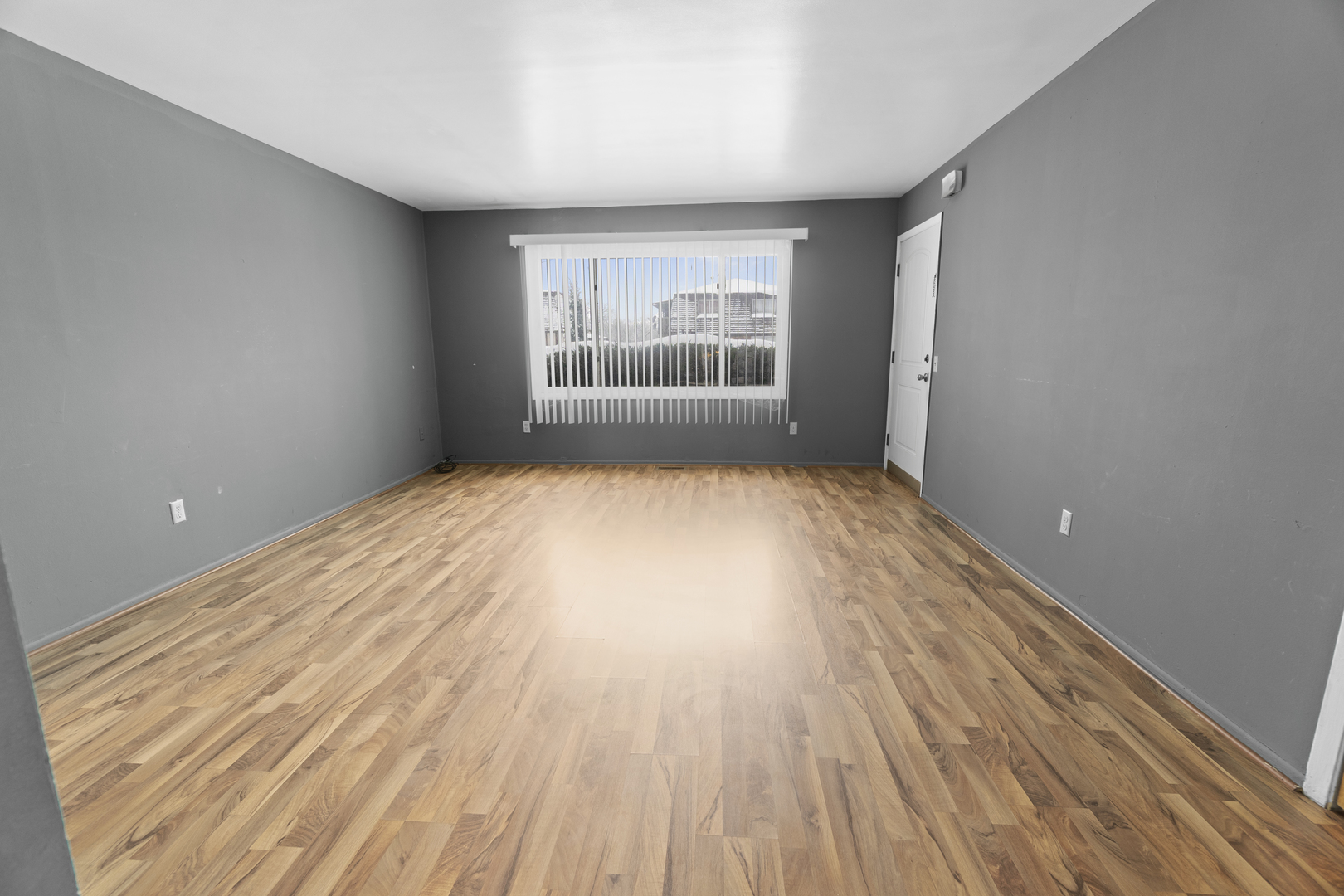 1017 9th Street, Unit 5 Harvard, IL 60033 - Photo 5 of 9 wooden floor in an empty room with a window