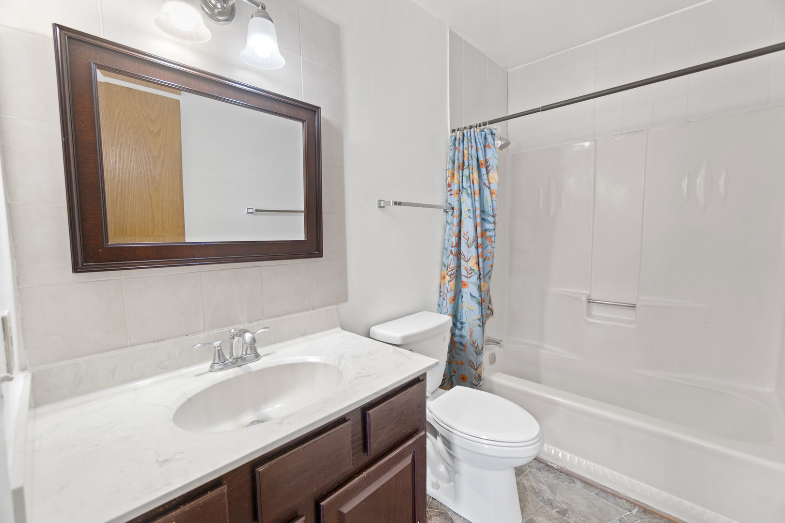 1017 9th Street, Unit 5 Harvard, IL 60033 - Photo 7 of 9 a bathroom with a sink toilet and shower
