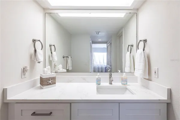 a bathroom with a sink and a mirror