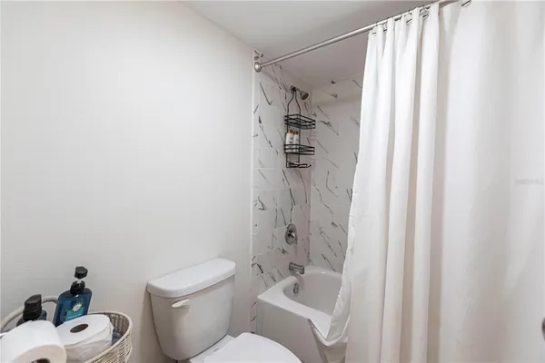a white toilet sitting next to a bathroom sink