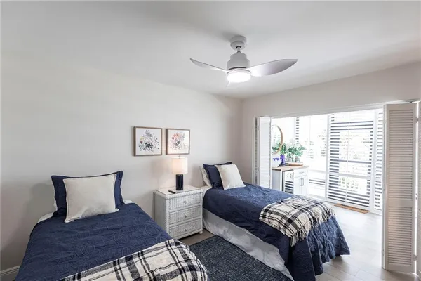a bedroom with a large bed and a chair