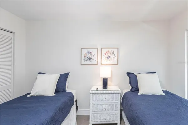 a bedroom with a bed and lamp