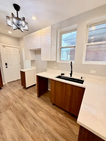 a kitchen with a sink cabinets and window