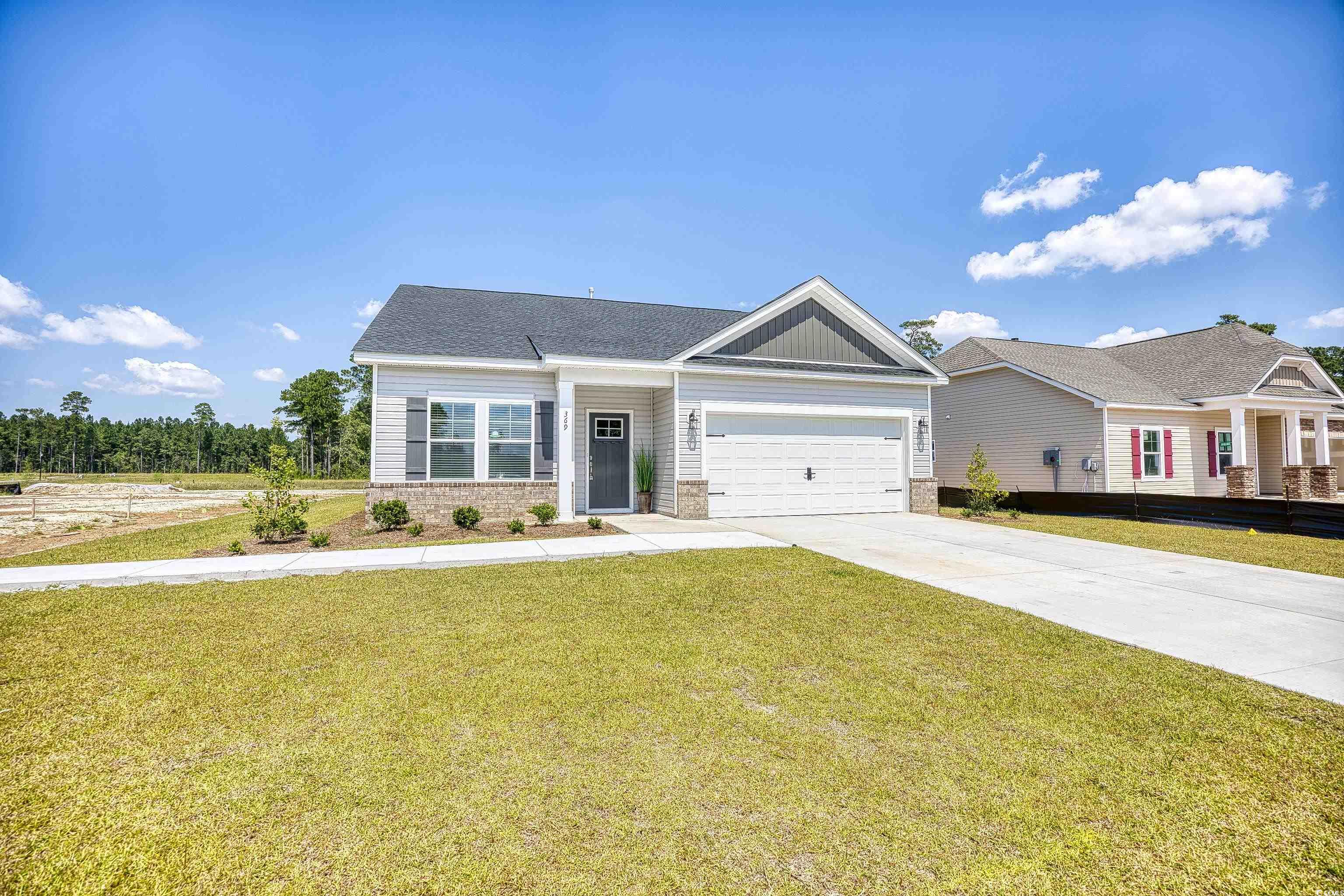 1028 Log Cabin Road Loris, SC 29569 - Photo 4 of 36 View of front of home featuring a garage and a fro