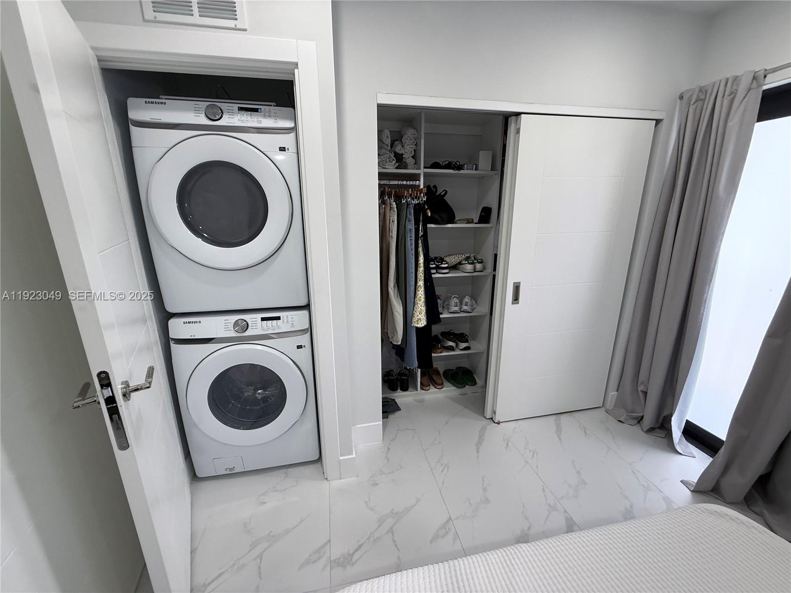 944 Jefferson Avenue, Unit 15 Miami Beach, FL 33139 - Photo 13 of 15 a utility room with dryer and washer