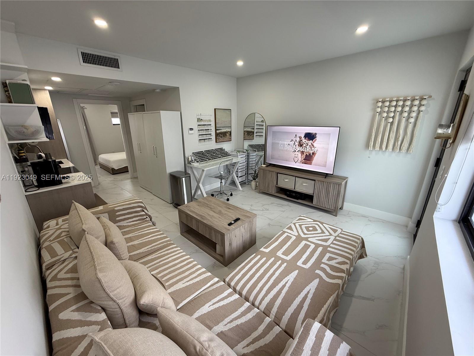 944 Jefferson Avenue, Unit 15 Miami Beach, FL 33139 - Photo 2 of 15 a living room with furniture and wooden floor