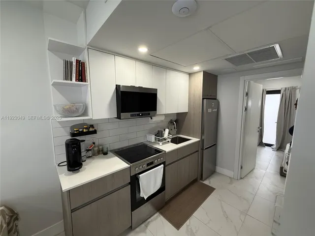 a kitchen with a sink and a stove top oven