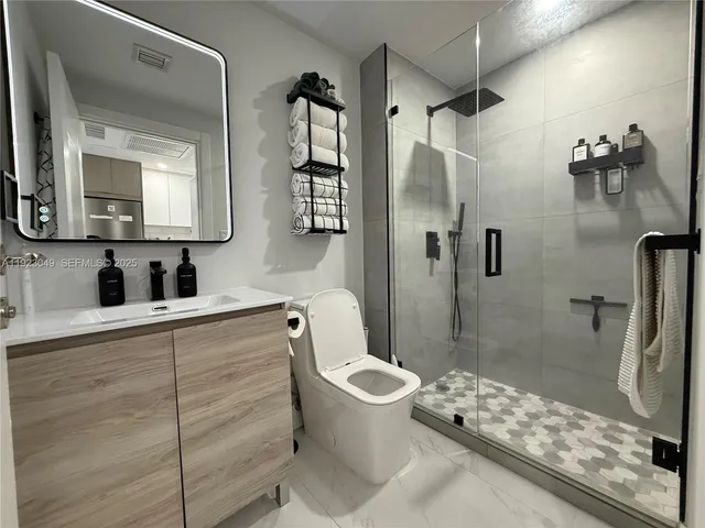 a bathroom with a sink toilet and shower