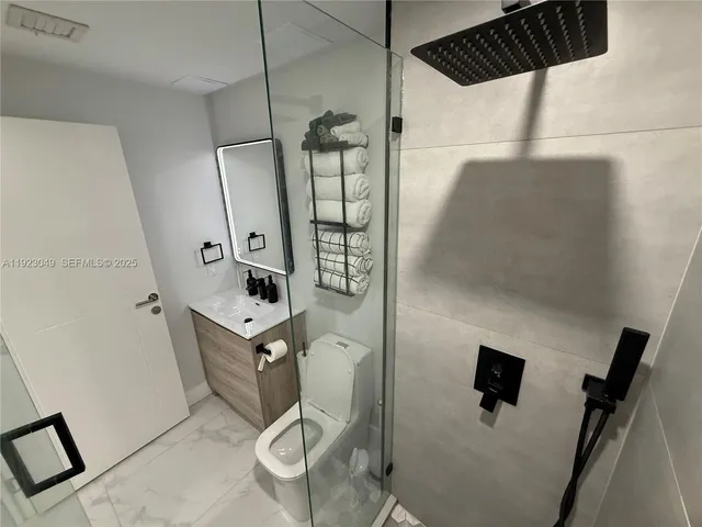 a bathroom with a mirror and a shower