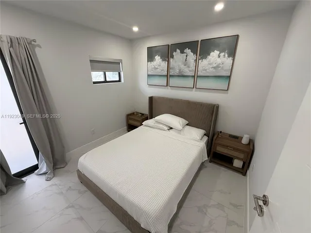 a bed sitting in a bedroom next to a window