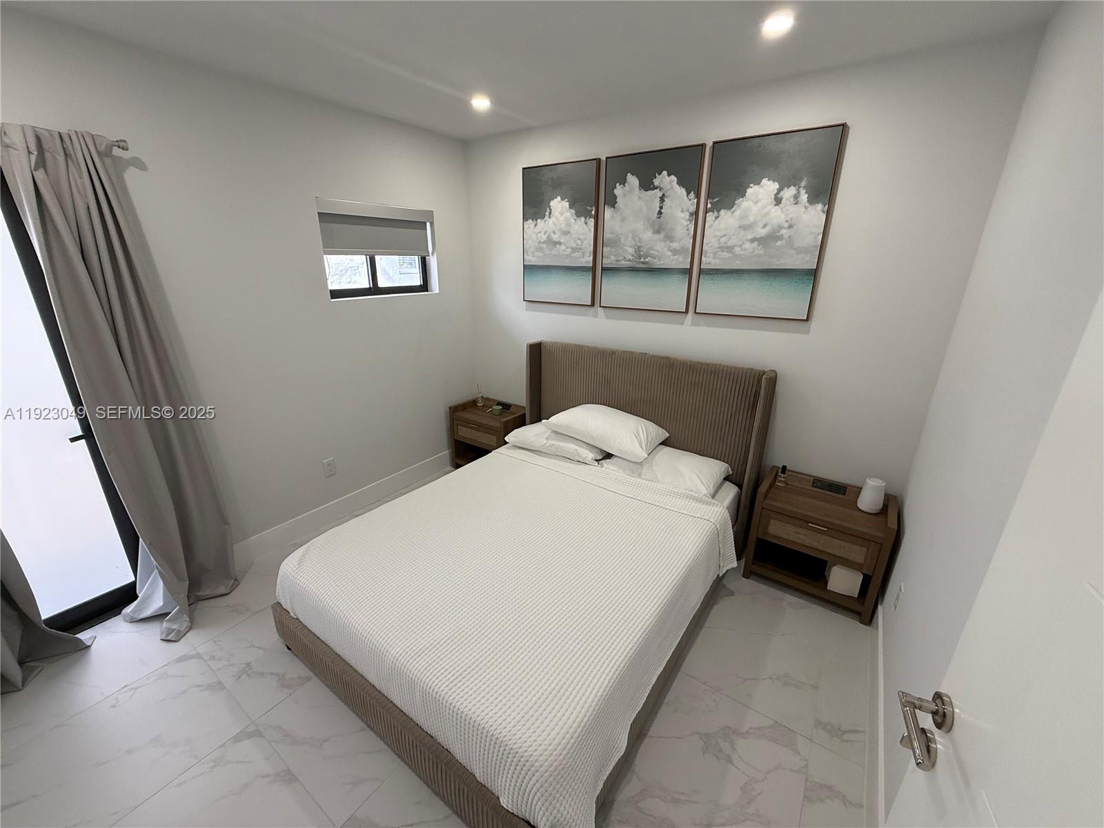 944 Jefferson Avenue, Unit 15 Miami Beach, FL 33139 - Photo 9 of 15 a bed sitting in a bedroom next to a window