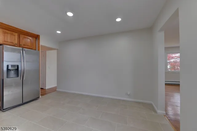 a kitchen with stainless steel appliances granite countertop a refrigerator a stove a sink and a microwave