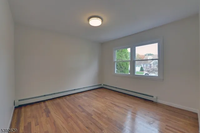 a view of an empty room and wooden floor