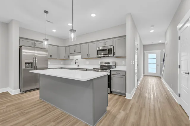 a kitchen with white cabinets and a sink