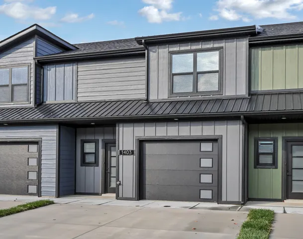 a view of empty room with wooden floor and window
