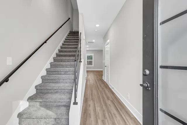 a large kitchen with kitchen island a sink stainless steel appliances and cabinets