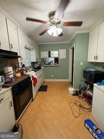 a kitchen with granite countertop a sink cabinets and stainless steel appliances