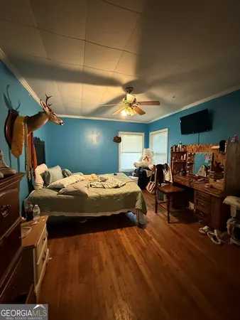 a bed sitting in a bedroom next to a window