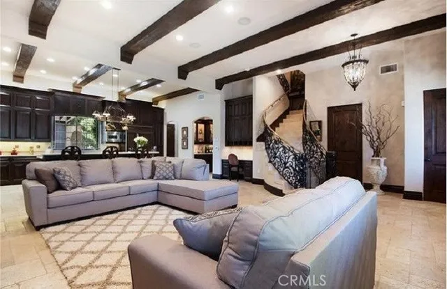 a view of living room kitchen with stainless steel appliances granite countertop furniture and a large window
