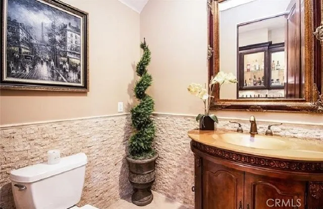 a kitchen with granite countertop wooden cabinets and stainless steel appliances