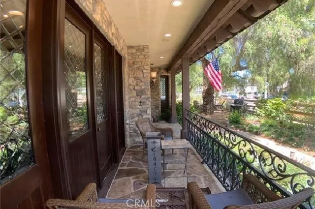 a large living room with a couch and chandelier