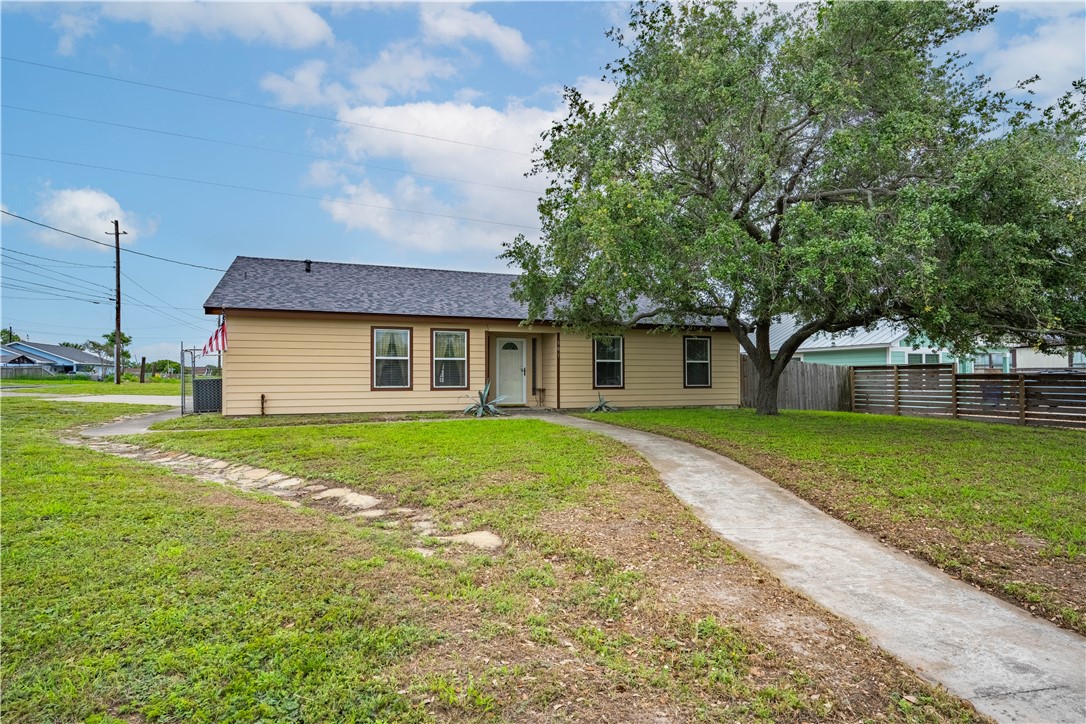 a front view of house with yard and green space