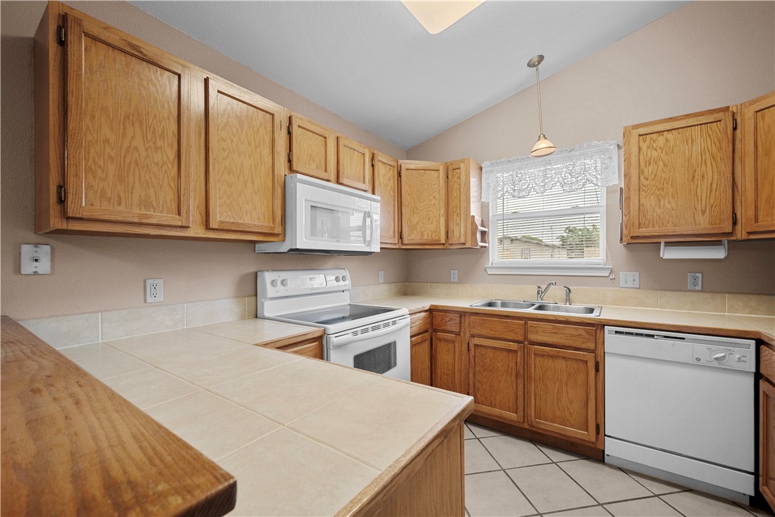 501 Jane Street Corpus Christi, TX 78418 - Photo 11 of 39 a kitchen with a sink stove and cabinets