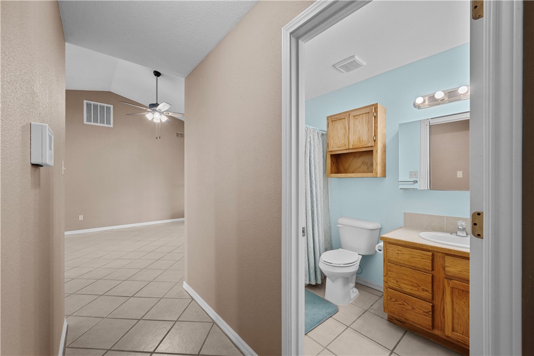 501 Jane Street Corpus Christi, TX 78418 - Photo 15 of 39 a bathroom with a toilet sink and a mirror