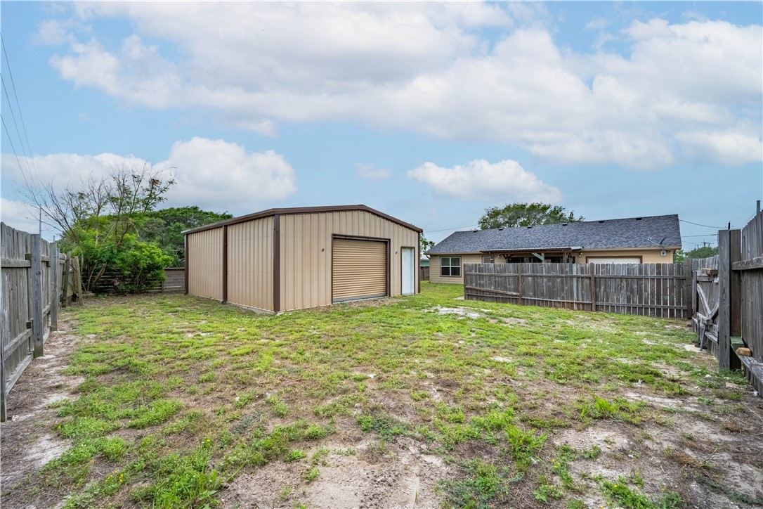 501 Jane Street Corpus Christi, TX 78418 - Photo 33 of 39 a backyard of a house with plants and large trees